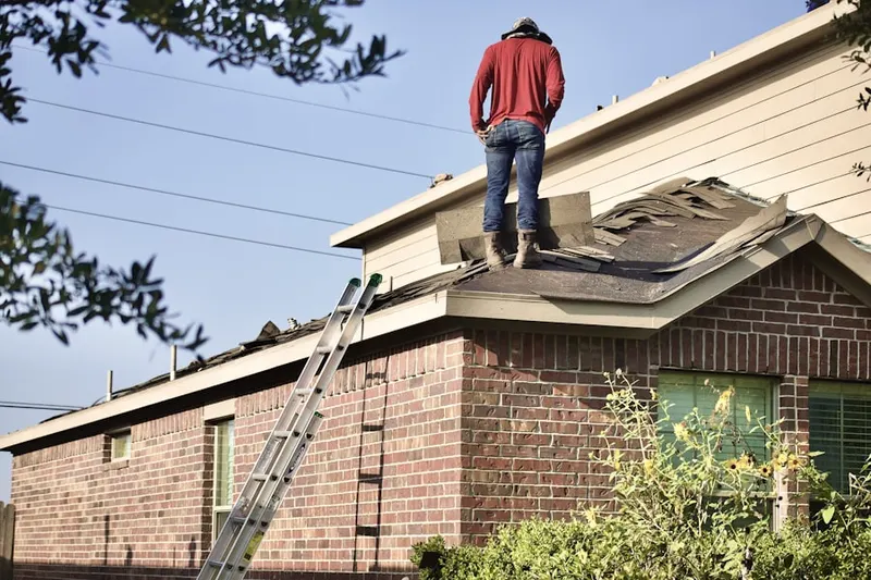 Professional roofer working on a residential roof in College Heights